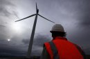 David Brockwell walks between wind turbines during a routine inspection at the Infigen Energy wind farm located on the hills surrounding Lake George, 50 km north of the Australian capital city of Canberra