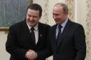 Russian President Vladimir Putin, right, shakes hands with Serbian Prime Minister Ivica Dacic during a meeting in the Novo-Ogaryovo residence outside Moscow, Wednesday, April 10, 2013. (AP Photo/Sergei Karpukhin, Pool)