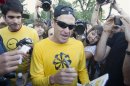 Lance Armstrong signs autographs following a run with his fans at Mount Royal park in Montreal