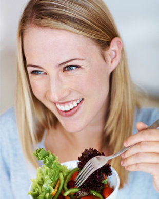 Woman eating healthy garden salad