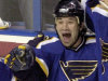 FILE - This is a April 13 2004 file photo of St. Louis Blues' Mike Danton as he  is congratulated by teammates  after his first-period goal against the San Jose Sharks in Game 4  of the first round of the NHL playoffs  in St. Louis USA. Mike Danton played the hero in his opening game of the Swedish league. The former NHL player, who served five years behind bars for a failed murder-for-hire plot, rushed to the aid of IFK Ore teammate Marcus Bengtsson, who was convulsing on the ice after a hard hit in the Sunday Sept. 18, 2011, season-opener. Danton, 30, was released from prison in 2009 and then played two seasons with Saint Mary's Huskies in Canadian university hockey before signing this summer with IFK Ore, which plays in the third tier of Sweden's pro system.< (AP Photo/Bill Boyce,file)