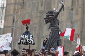 People carry Lebanese national flags as one of them &hellip;