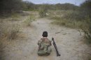 A Somali National Army soldier rests on the frontline with his RPG launcher beside him, while marching towards the town of Buurhakaba from Leego