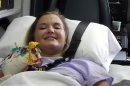 In this Monday, July 2, 2012 file photo provided by Andy Copeland, Aimee Copeland smiles as she leaves a hospital in Augusta Ga., headed for an inpatient rehabilitation clinic. On Wednesday, Aug. 22, 2012, after more than three months in the hospital and a rehabilitation clinic, Copeland, who survived a rare fleshing-eating disease but had both her hands, her left leg and her right foot amputated, returned home to a family dinner and a wheelchair-accessible house now equipped with an exercise room and private elevator. (AP Photo/Courtesy Andy Copeland, File)