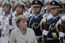 German Chancellor Merkel inspects an honour guard during an official welcoming ceremony in Beijing