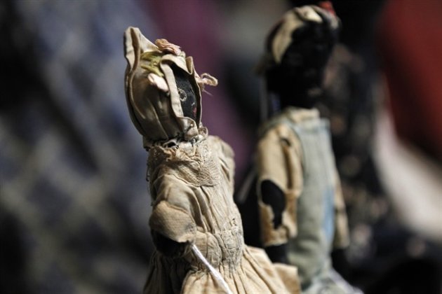In this Wednesday, July 25, 2012 photo, historic black cloth dolls appear on display in New Orleans. Amid rare antique dolls crafted in porcelain, whimsical Kewpies and homage to contemporary icon Barbie, cloth dolls in the image of African-Americans drew special attention as more than 1,200 collectors gathered in New Orleans for the annual convention of the United Federation of Doll Clubs. (AP Photo/Gerald Herbert)