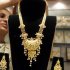 Worker displays gold jewellery at shop in Mumbai