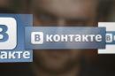 A man looks at a computer screen showing logos of Russian social network VKontakte in Moscow