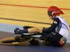 Britain's Philip Hindes sits on the ground as he waits for assistance after falling during their track cycling men's team sprint qualifying heats at the Velodrome during the London 2012 Olympic Games