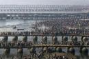 FILE - In this Feb. 10, 2013 file photo, Hindu devotees walk across pontoon bridges to take a holy dip at Sangam, the confluence of the Ganges, Yamuna and mythical Saraswati River, during the Maha Kumbh festival, in Allahabad, India. Philippine officials estimate that as many as 6 million people will attend the Mass that Pope Francis celebrates Sunday, Jan. 18, 2015 in Manila's Rizal Park. That would be a record for any pope, but not for any event. A look at some of the biggest gatherings of humanity: (AP Photo/Manish Swarup, File)