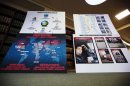 Charts showing information related to eight members belonging to a New York-based cell of a global cyber criminal organization are displayed at a news conference in New York