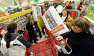 <p>               FILE - In this Nov. 25, 2011 file photo, shoppers scramble for door buster deals at Target, in Bowling Green, Ky. U.S. consumers spent at a lackluster rate in November as their incomes barely grew, suggesting that U.S. households may struggle to sustain their spending into 2012.(AP Photo/Daily News, Joe Imel, File)