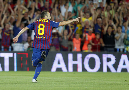 FC Barcelona's Andres Iniesta celebrates his goal during a second leg Spanish Supercup soccer match against Real Madrid at the Camp Nou stadium in Barcelona, Spain, Wednesday, Aug. 17, 2011. (AP Photo/Andres Kudacki)