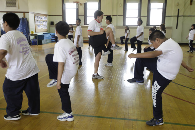 <p>               CORRECTS INFORMATION REGARDING THE STUDY'S RELEASE - FILE - In this May 26, 2009 file photo, Betty Hale, center, instructs a physical education class at Eberhart Elementary School in Chicago. Conventional wisdom says school gym classes make a big difference in kids' weight. But a report in the Thursday, Jan. 31, 2013 issue of the New England Journal of Medicine says this is one of many myths that are detracting from real solutions to the nation's weight problems. According to the report, gym classes often are not long, often or intense enough to make much difference. (AP Photo/M. Spencer Green, File)