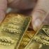 An employee picks up a gold bar at the Austrian Gold and Silver Separating Plant 'Oegussa' in Vienna