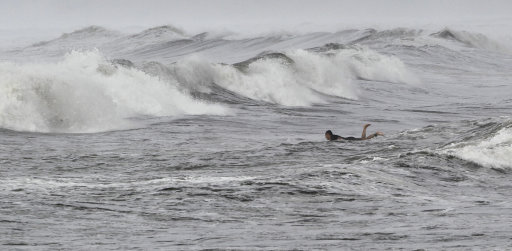 A surfer prepares to ride a wave at Nishihara beach in Fujisawa, near Tokyo, Saturday, Sept. 3, 2011. Slow-moving Typhoon Talas reached southern Japan, bringing heavy rain and strong winds across a wide swath of the country. (AP Photo/Koji Sasahara)