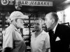 FILE - In this  May 12, 1959, American novelist Ernest Hemingway, left, speaks with actors Alec Guinness, center, and Noel Coward in Sloppy Joe's Bar during the making of Sir Carol Reed's film version of "Our Man in Havana," based on Graham Greene's best seller, in Havana, Cuba.  Sloppy Joe's will be reopened in February 2013 by the state-owned tourism company Habaguanex, part of an ambitious revitalization project by the Havana City Historian's Office, which since the 1990's has transformed block after block of crumbling ruins into rehabilitated buildings along vibrant cobblestone streets, giving residents and tourists from all over the chance to belly up to the same bar that served thirsty celebrities like Rock Hudson, Babe Ruth and Ernest Hemingway. (AP Photo, File)