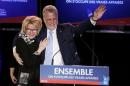 Quebec Liberal leader Couillard takes the stage with his wife Pilote at his rally headquarters after his in St. Felicien