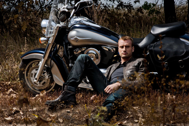 In this November 2011 photo provided by STB Channel, Francis Mathew, 33, a British photographer and descendant of Russia?s last Czar Nicholas II, poses for a photo with a with a motorcycle outside Kiev. Mathew, the great great nephew of Nicholas II, was cast for the second season of the Ukrainian version of the popular U.S. show, in which an unmarried man selects a fiancee through a series of dates and romantic getaways. (AP Photo/ Sergei Yushkov, STB Channel, HO)
