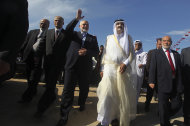 FILE- In this Tuesday, Oct. 23, 2012 file photo, the Emir of Qatar Sheik Hamad bin Khalifa al-Thani, second right, and Gaza's Hamas Prime minister Ismail Haniyeh, third left, arrive for the corner-stone laying ceremony of a new center providing artificial limbs, in Bait Lahiya, northern Gaza Strip. (AP Photo/Ali Ali, Pool, File)