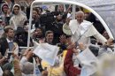 Pope Francis waves to pilgrims as he arrives to Aparecida Basilica in Aparecida, Brazil, Wednesday, July 24, 2013. Pope Francis, the first pontiff from the Americas, arrived to the basilica that holds Brazil's patron saint, the dark-skinned Virgin of Aparecida. (AP Photo/Andre Penner)
