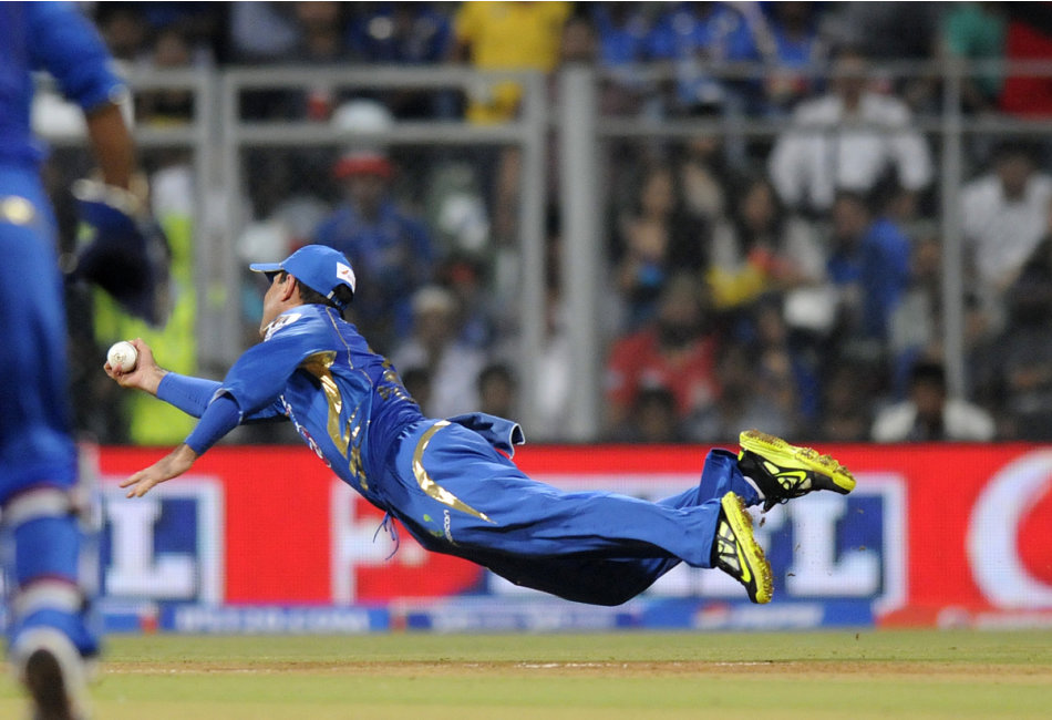 Ricky Ponting captain of Mumbai Indians dives to complete a catch to get Unmukt Chand of Delhi Daredevils out during match 10 of the Pepsi Indian Premier League ( IPL) 2013  between The Mumbai Indians