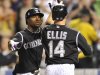 Colorado Rockies' Mark Ellis (14) is congratulated by Eric Young Jr. (1) after hitting a two run home run off San Diego Padres relief pitcher Cory Luebke during the sixth inning of a baseball game in Denver, Monday, Sept. 19, 2011. (AP Photo/Jack Dempsey)