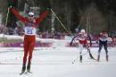 Switzerland's Dario Cologna celebrates winning the gold medal as Norway's Martin Johnsrud Sundby, second from right, and Russia's Maxim Vylegzhanin are to cross the finish line during the men's cross-country 30k skiathlon at the 2014 Winter Olympics, Sunday, Feb. 9, 2014, in Krasnaya Polyana, Russia. (AP Photo/Gregorio Borgia)