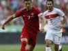 Portugal's Cristiano Ronaldo runs with the ball past Turkey's Hamit Altintop during their international friendly soccer match at Luz stadium in Lisbon
