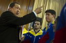 Venezuela's President Hugo Chavez talks to a group of engineers before their travel to China to get training on the operation of the new Miranda Satellite, at the Miraflores Palace in Caracas