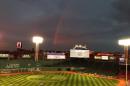 Boston Red Sox players take batting practice as a rainbow appears in the sky above Fenway Park Tuesday, Oct. 22, 2013, in Boston. The Red Sox are scheduled to host the St. Louis Cardinals in Game 1 of baseball's World Series on Wednesday. (AP Photo/Ron Blum)