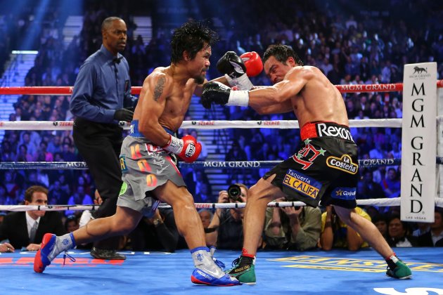LAS VEGAS, NV - DECEMBER 08:  (L-R) Manny Pacquiao throws a left at Juan Manuel Marquez during their welterweight bout at the MGM Grand Garden Arena on December 8, 2012 in Las Vegas, Nevada.  (Photo by Al Bello/Getty Images)