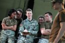 In this photo provided by the National Theatre Wales, on Friday April 20, 2012 Matthew Aubrey,center, plays U.S. Army Pfc. Bradley Manning in the play 