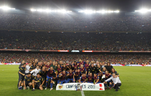 FC Barcelona's players pose together with the trophy after beating Real Madrid in their Super Cup final second leg soccer match at the Camp Nou Stadium in Barcelona, Spain, Wednesday, Aug. 17, 2011. (AP Photo/Andres Kudacki)