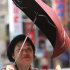 A Taiwanese woman holds her umbrella tight against powerful gusts of wind generated by typhoon Nanmadol in Taipei, Taiwan, Monday, Aug. 29, 2011. Typhoon Nanmadol has slammed into Taiwan, closing schools, workplaces and government offices. It has dumped more than 19 inches (half a meter) of rain in the mountainous south, where vulnerability to catastrophic landslides prompted the evacuation of some 8,000 people. (AP Photo/Chiang Ying-ying)