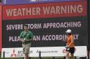 Fans head for shelter as an approaching storm stops play during the first round of the St. Jude Classic golf tournament Thursday, June 5, 2014, in Memphis, Tenn. (AP Photo/Mark Humphrey)