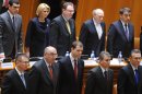 Romanian Prime Minister Mihai Razvan Ungureanu (bottom left) stands next to government members in the parliament