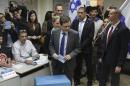 Zionist Union leader Isaac Herzog accompanied by his wife Michal prepares to cast his vote in Tel Aviv, Israel, Tuesday, March 17, 2015. Israelis are voting in early parliament elections following a campaign focused on economic issues such as the high cost of living, rather than fears of a nuclear Iran or the Israeli-Arab conflict. (AP Photo/Ariel Schalit)