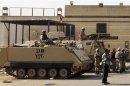 Egyptian army soldiers guard with APC in front of main gate of Torah prison where former President Mubarak is detained in, on outskirts of Cairo