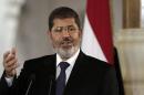 FILE - In this July 13, 2012 file photo, then Egyptian President Mohammed Morsi speaks to reporters at the presidential palace in Cairo. Egypt's prosecutors referred to trial Sunday, Jan. 19, 2014, the country's former Islamist president on charges of insulting the judiciary and defaming its members to spread hate - the fourth case filed against Mohammed Morsi since his July ouster, the state news agency reported. (AP Photo/Maya Alleruzzo, File)