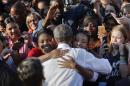 President Barack Obama is embraced by two women while greeting supporters at the University of North Carolina in Chapel Hill, N.C., Wednesday, Nov. 2, 2016. Obama is in North Carolina to help turn out the vote for Democratic presidential candidate Hillary Clinton with a rally in Chapel Hill. It's the first of two visits Obama has planned this week to North Carolina. (AP Photo/Pablo Martinez Monsivais)