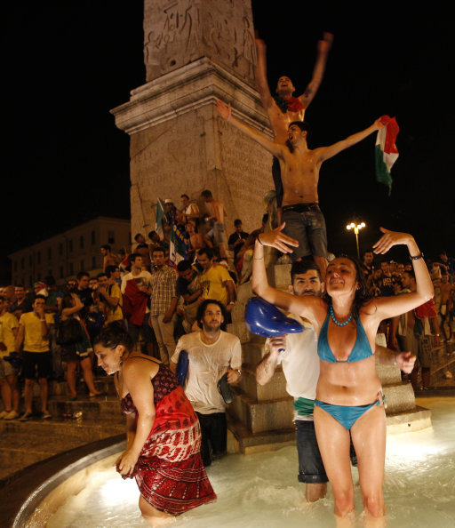 Italian soccer fans celebrate in Piazza del Popolo square in Rome, after Italy's victory against Germany in the Euro 2012 soccer championship semifinal match Thursday, June 28, 2012. (AP Photo/Alessandra Tarantino)