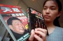 AN OFFICE WORKER SHOWS BOOKS ABOUT CHEN XITONG IN BEIJING.