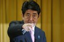 Japan's next PM Abe points during a news conference in Tokyo