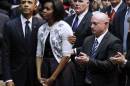 File photo of U.S. President and Mrs. Obama under the watchful eye of then-Secret Service Agent Clancy in Tucson