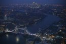 Tower Bridge and the Canary Wharf financial district are seen at dusk in an aerial photograph from The View gallery at the Shard, western Europe's tallest building, in London