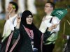 Saudi Arabia's Wojdan Ali Seraj Abdulrahim Shaherkani gestures as she walks with the contingent in the atheletes parade during the opening ceremony of the London 2012 Olympic Games at the Olympic Stadium