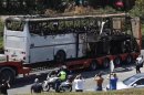 A truck carries a bus, that was damaged in a bomb blast on Wednesday, outside Burgas Airport