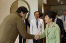 In this photo released by the South Korean presidential house, South Korean President Park Geun-hye, right, shakes hands with U.S. Ambassador to South Korea Mark Lippert at Severance Hospital where he is hospitalized, in Seoul, South Korea, Monday, March 9, 2015. Injured U.S. Ambassador Lippert is recovering from the March 5 attack by a knife-wielding anti-U.S. activist. (AP Photo/South Korean Presidential House) EDITORIAL USE ONLY