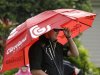 Charlie Beljan holds an umbrella as he waits his turn to tee off in the first round at the Tournament of Champions golf tournament on Friday, Jan. 4, 2013, in Kapalua, Hawaii. (AP Photo/Elaine Thompson)